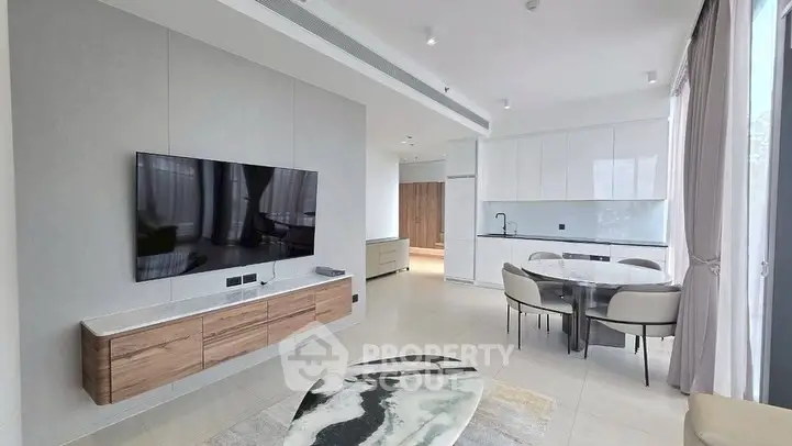 Modern living room with sleek TV setup and elegant dining area