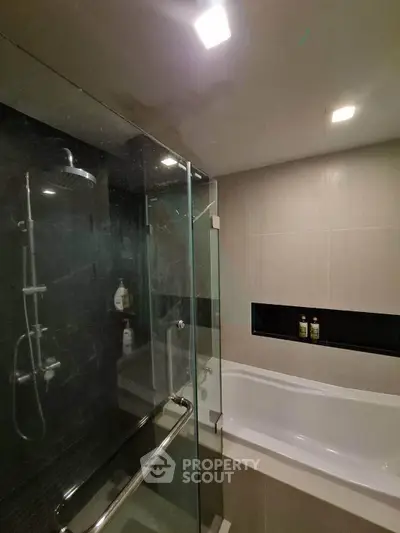 Modern bathroom with glass shower and bathtub in sleek design