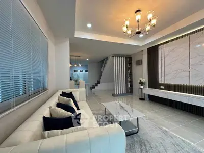 Luxurious modern living room with elegant marble accents and stylish lighting