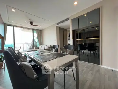 Modern living room with elegant dining area and city view balcony.