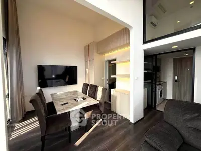 Modern living room with dining area and open kitchen in stylish apartment