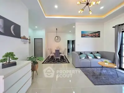 Modern living room with stylish decor and open layout, featuring elegant furniture and natural light.