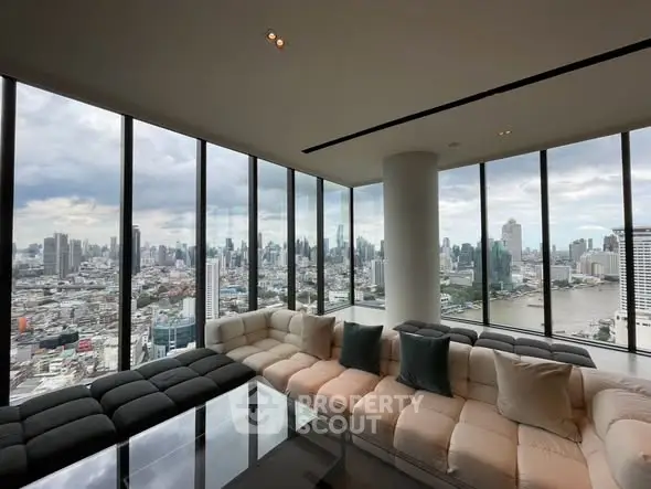 Luxurious corner unit living room with panoramic city skyline views and modern furnishings.