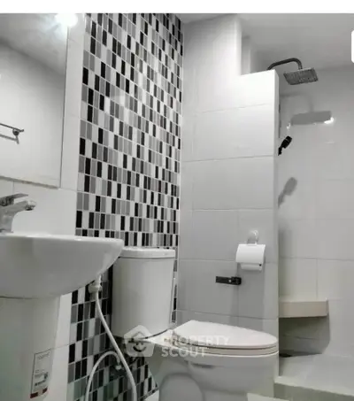 Modern bathroom with stylish black and white tile design and sleek fixtures.