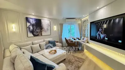 Luxurious living room with modern decor, large sectional sofa, and wall-mounted TV, perfect for relaxation.