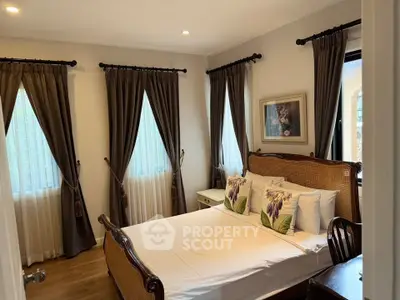 Charming bedroom with elegant decor and natural light, perfect for relaxation.
