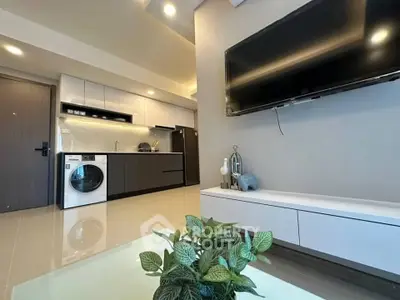 Modern open-layout kitchen with sleek appliances and stylish living area, perfect for contemporary living.