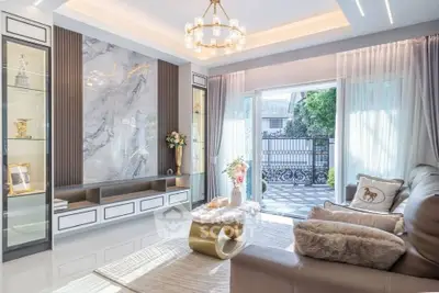 Luxurious living room with elegant decor and large windows offering garden view
