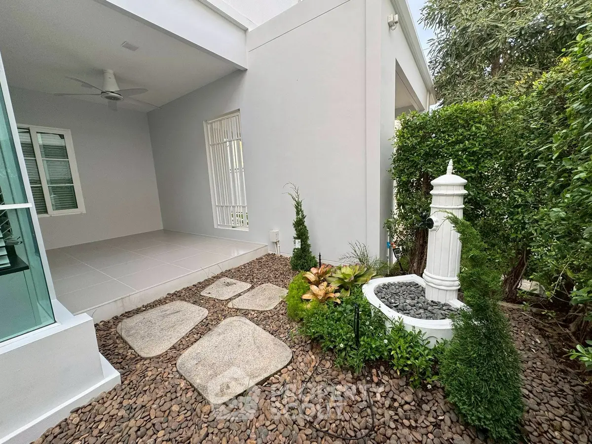 Charming garden with decorative fountain and patio in modern home exterior