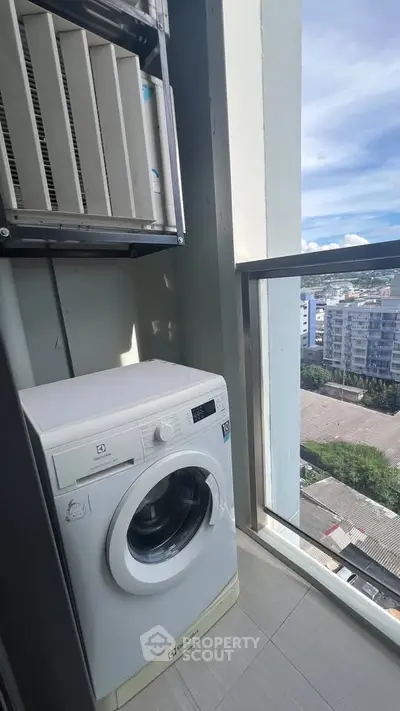 High-rise apartment balcony with washing machine and city view