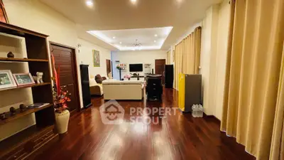 Spacious living room with wooden flooring and elegant decor