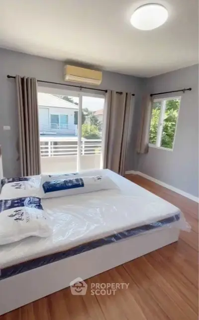 Bright and airy bedroom with large window and modern decor