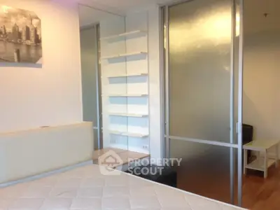 Modern bedroom with frosted glass sliding doors and built-in shelving