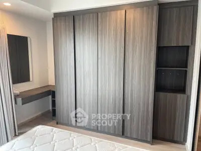 Modern bedroom with sleek wardrobe and cozy mattress, perfect for stylish living.