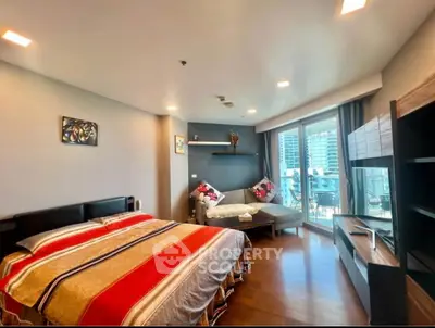 Spacious bedroom with modern decor and balcony access in luxury apartment