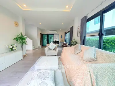Spacious modern living room with large windows and stylish decor