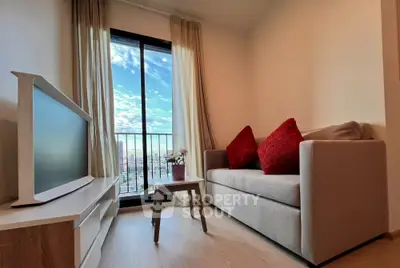 Cozy living room with modern decor and stunning city view from balcony.
