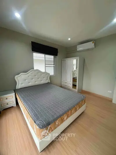 Spacious bedroom with modern furnishings and natural light