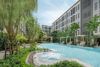 Luxurious apartment complex with stunning pool and lush greenery, perfect for relaxation and modern living.