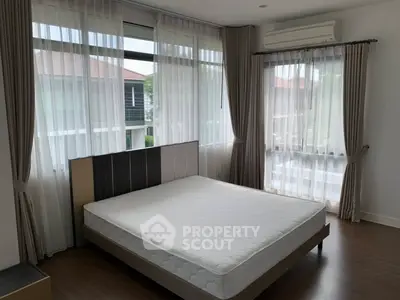 Spacious bedroom with large windows and modern decor