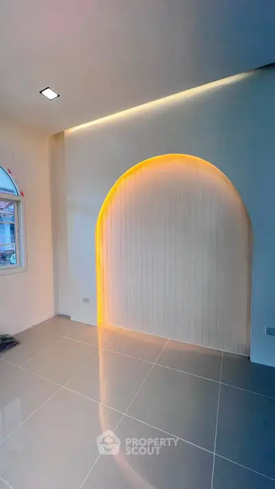 Modern interior with unique arch feature and sleek tile flooring
