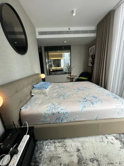 Luxurious bedroom with modern decor and large mirror, perfect for relaxation.