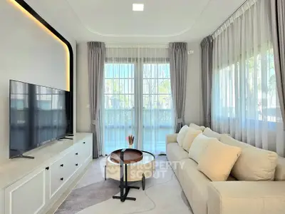 Elegant living room with large windows, modern decor, and a cozy sofa, perfect for relaxation and entertainment.