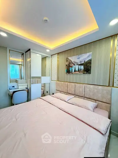 Luxurious bedroom with modern decor and ambient lighting, featuring a cozy bed and stylish wall art.