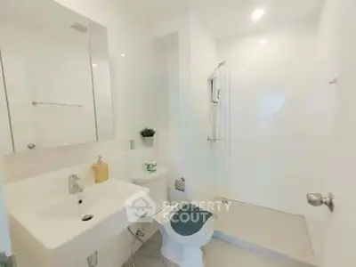 Modern minimalist bathroom with sleek fixtures and walk-in shower