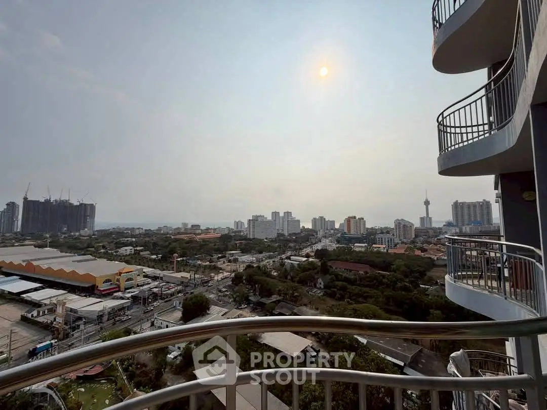 Stunning cityscape view from a high-rise balcony with modern railings and urban skyline.