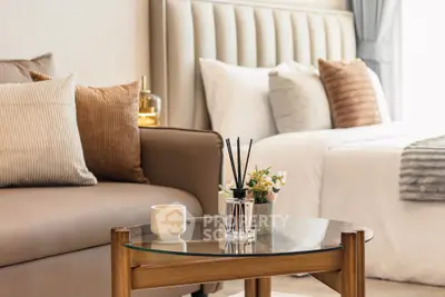 Luxurious bedroom with elegant decor and cozy seating area, perfect for relaxation and comfort.