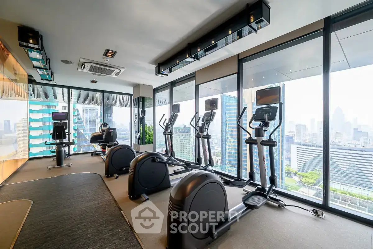 Modern gym with panoramic city views and state-of-the-art fitness equipment.