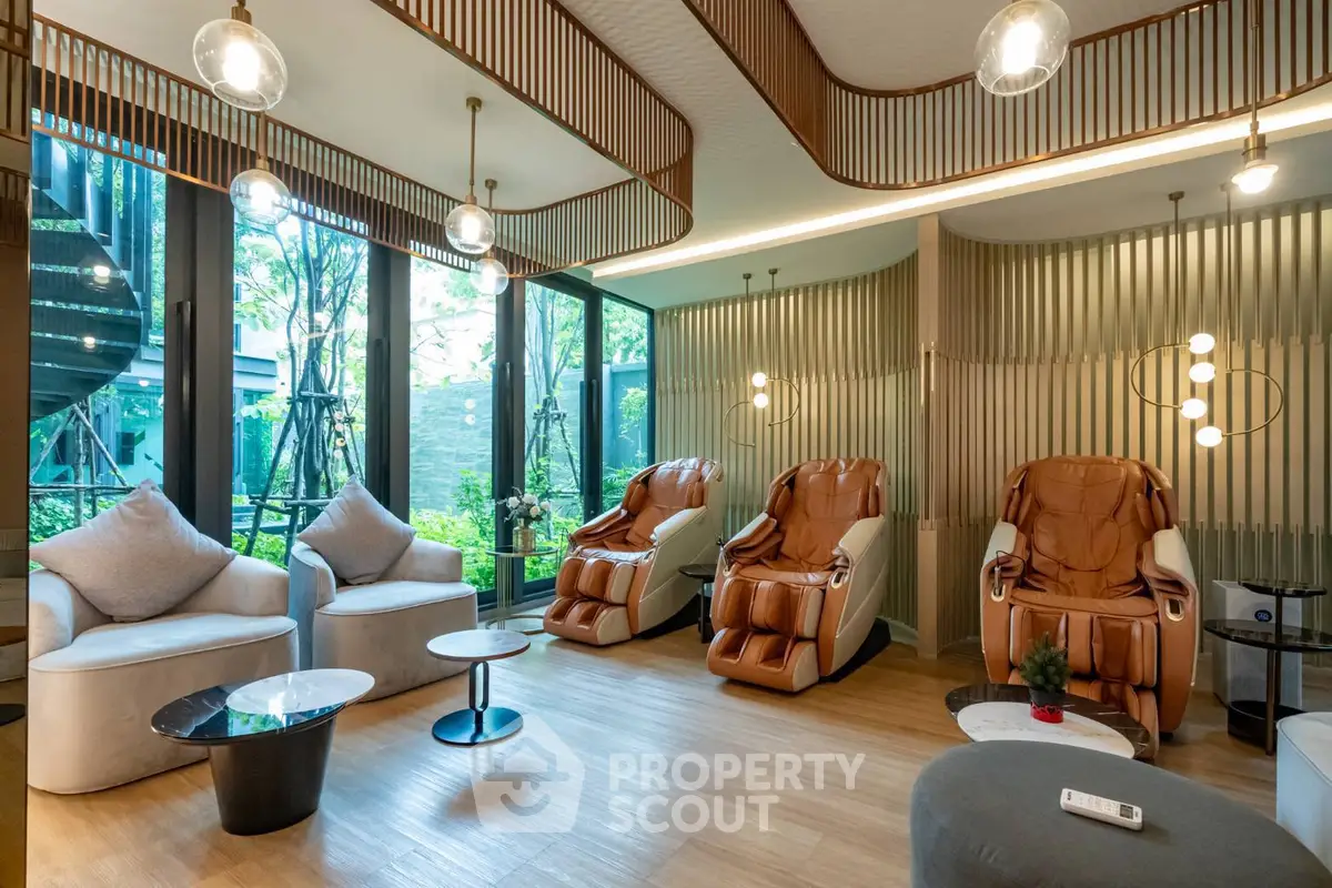 Luxurious living room with massage chairs and modern decor, perfect for relaxation.