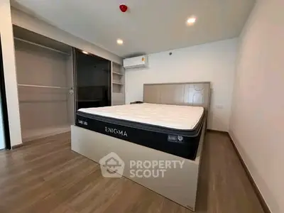 Modern bedroom with sleek design and spacious wardrobe in a contemporary apartment.