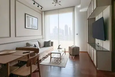 Modern living room with city view, stylish furniture, and natural light.