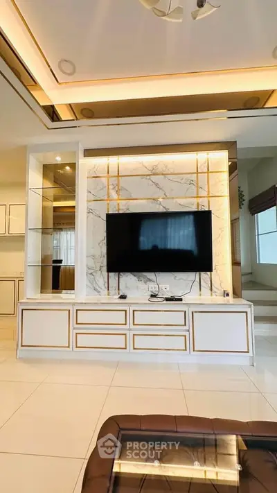 Luxurious living room with marble accent wall and modern TV setup