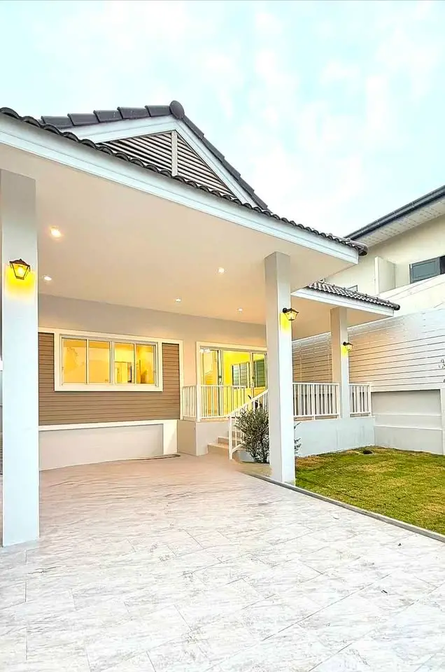 Charming modern house exterior with spacious driveway and elegant lighting, perfect for family living.