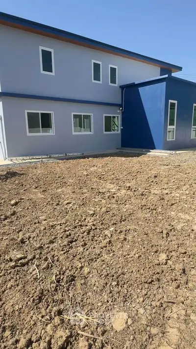 Modern two-story building with blue accents and large windows