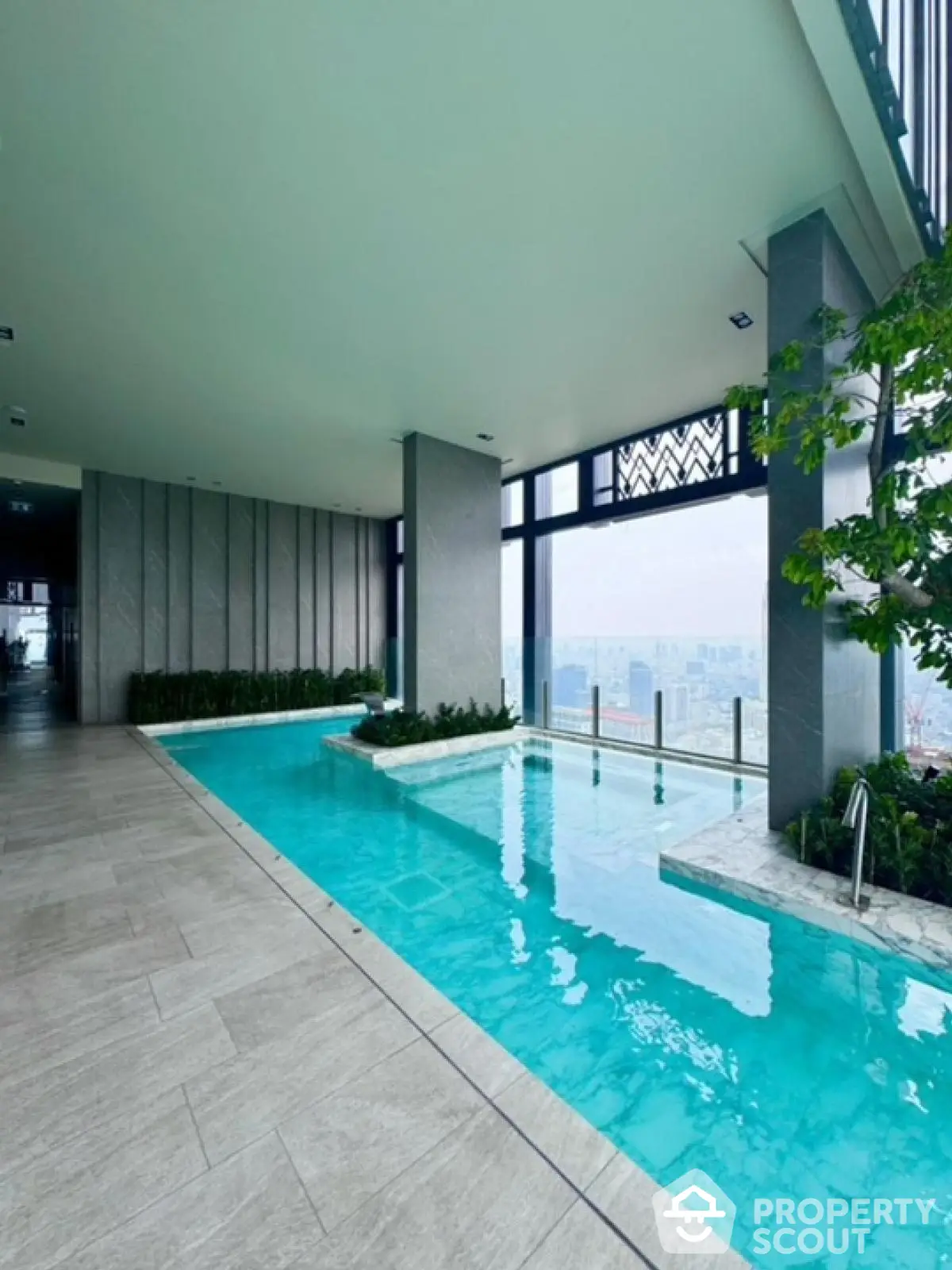 Luxurious indoor pool with stunning city view in modern high-rise building