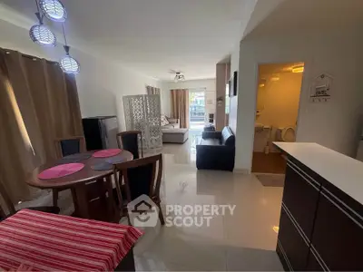 Spacious open-plan living room with modern dining area and cozy seating.