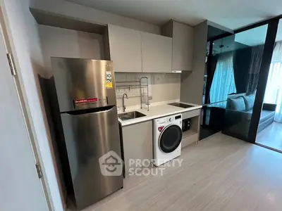 Modern kitchen with sleek appliances and open layout in stylish apartment