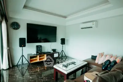 Spacious living room with modern entertainment setup and stylish decor