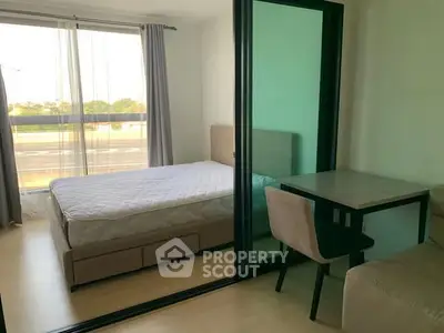 Modern bedroom with glass partition and cozy workspace