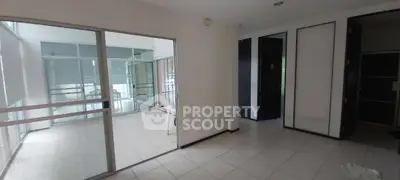 Spacious modern interior with glass doors and tiled flooring, ideal for versatile living or office space.