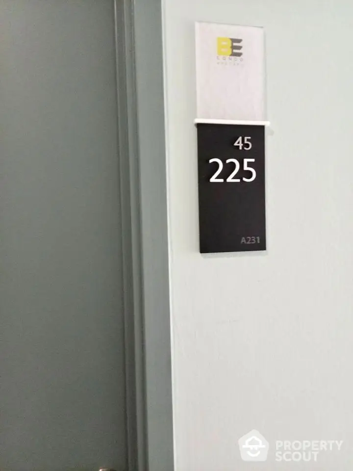 Condo unit door with room number 225 and building signage