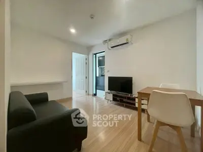 Modern living room with sleek furniture and air conditioning, perfect for cozy gatherings.