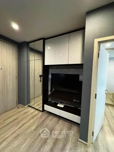 Modern living room with sleek built-in storage and stylish flooring