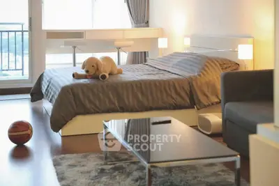 Modern bedroom with plush decor and city view, featuring a cozy bed and stylish furnishings.