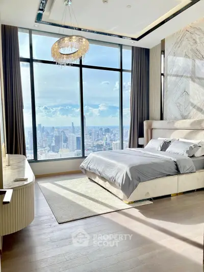 Luxurious bedroom with stunning city view and elegant chandelier