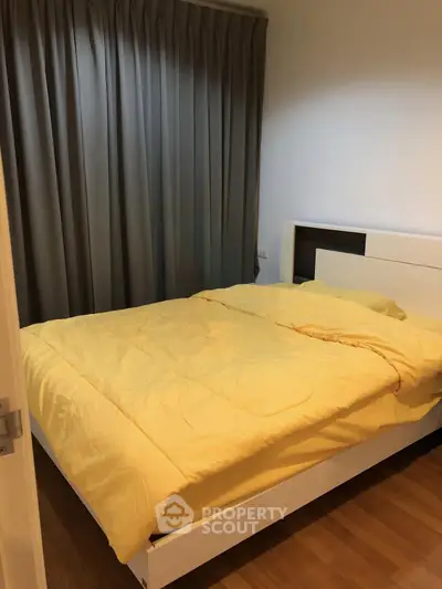 Cozy bedroom with modern design and warm lighting, featuring a comfortable bed and elegant curtains.